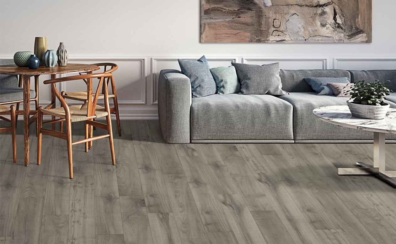 Living room with laminate flooring in Dothan, AL, and brown grey couch